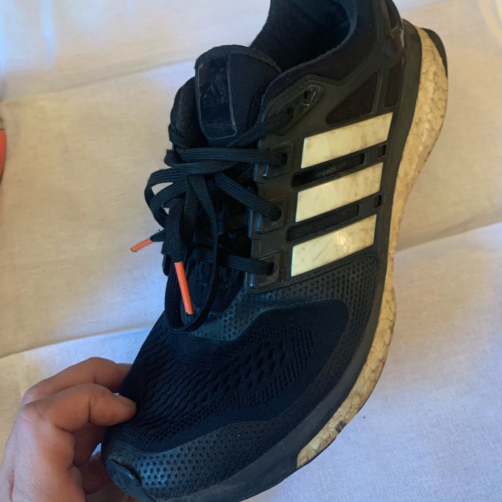 Adidas running shoes with classic stripes.